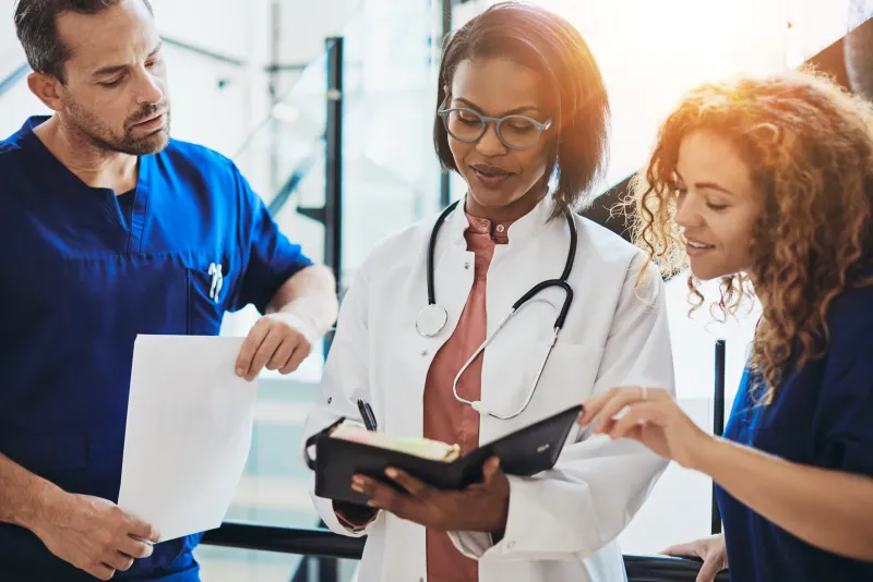 Doctors and staff reviewing a chart together