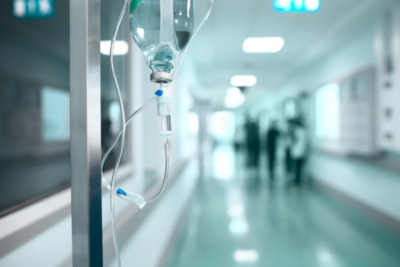 An IV stand in a bright clinic corridor
