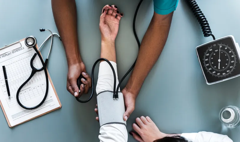 A clinician taking a patient's blood pressure