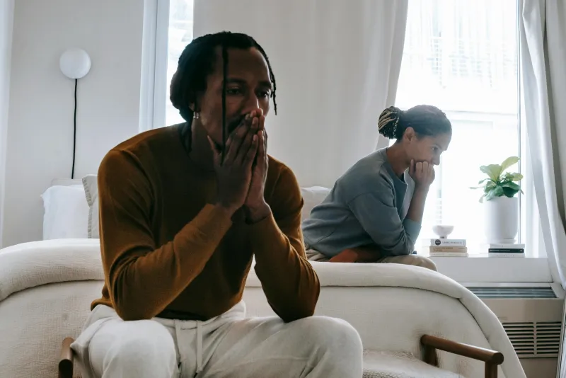 A person sitting thoughtfully in a bright room