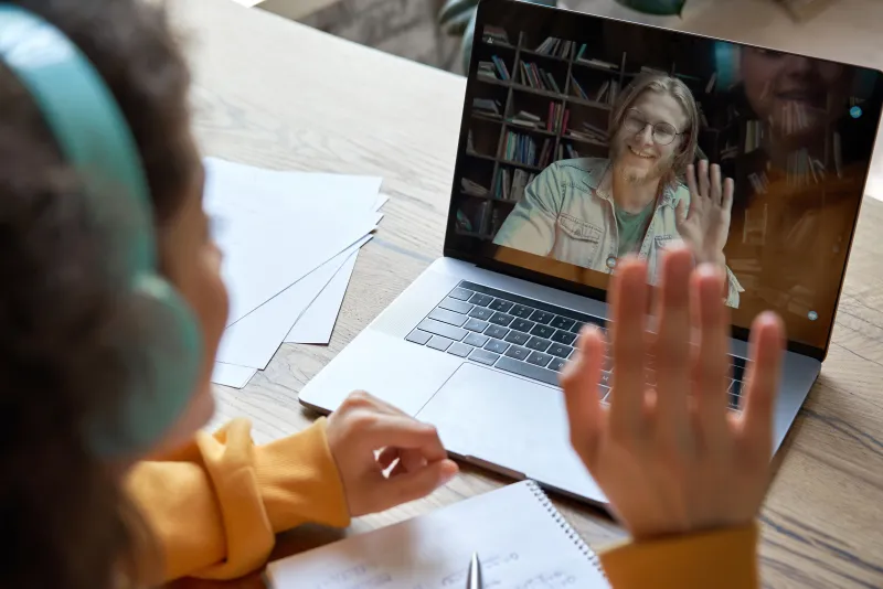 A patient on a video visit with a clinician on a laptop